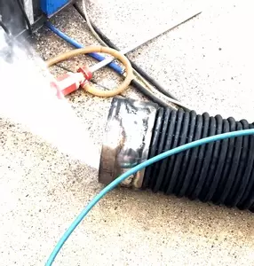 Old burst heating coil from Nilfisk Contractor pressure washer being pressure tested to find the leak.